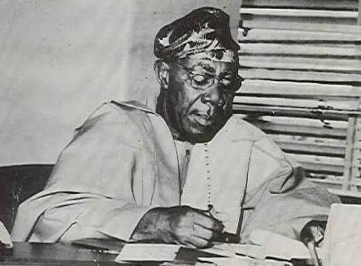 Archival photograph of Chief Timothy Adeola Odutola at his desk